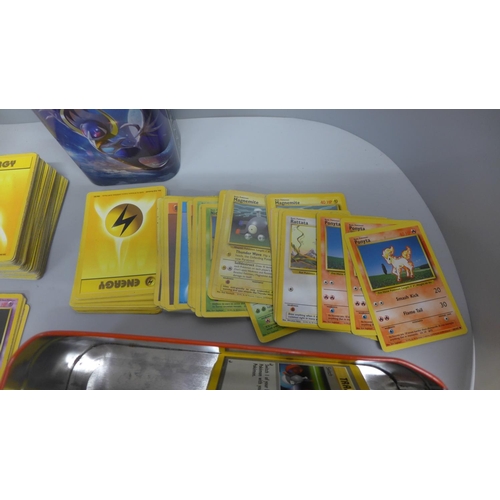 761 - 700 Pokemon base set cards including collector tins and book, etc.