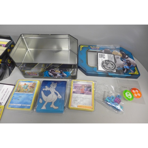 767 - Assorted Pokemon cards with Holos and collector tins