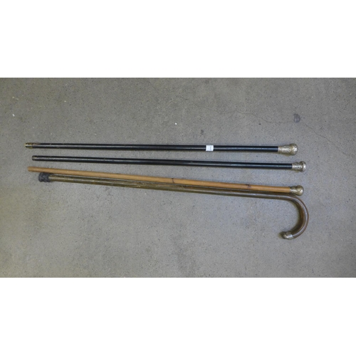 822 - Four silver topped walking sticks and canes