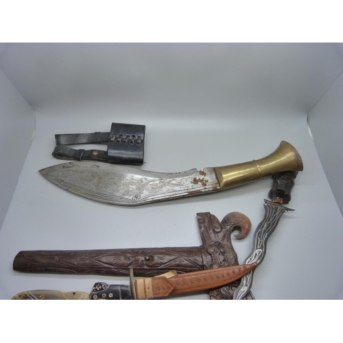 824 - A Nepalese kukri with engraved blade, decorative leather scabbard with regimental badge, buttons and... 