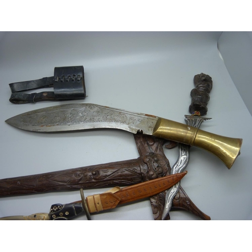 824 - A Nepalese kukri with engraved blade, decorative leather scabbard with regimental badge, buttons and... 