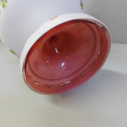 828 - An opaline overlay cranberry glass footed bowl, 17.5cm