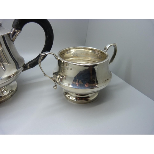 835 - A three piece silver tea service, Birmingham 1938,  by Dennison, 583g