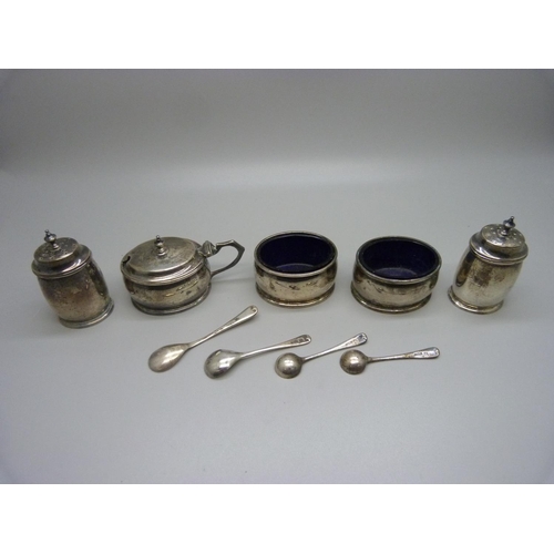 864 - A five piece silver cruet set with three matching spoons and blue glass liners, Birmingham 1928, 165... 