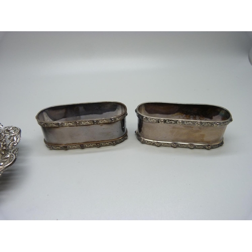 869 - A pair of Celtic design silver napkin rings, Birmingham 1947, and a pierced silver dish, Chester 189... 