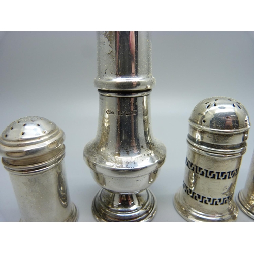 870 - Three silver pepper pots and a silver salt pot, 78g