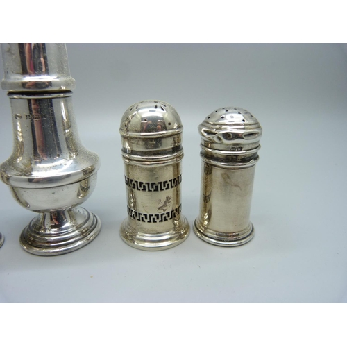 870 - Three silver pepper pots and a silver salt pot, 78g