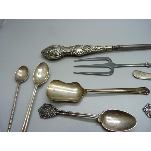 900 - Ten silver spoons and a silver napkin ring, 160g, a button hook and a fork