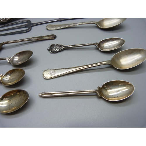 900 - Ten silver spoons and a silver napkin ring, 160g, a button hook and a fork