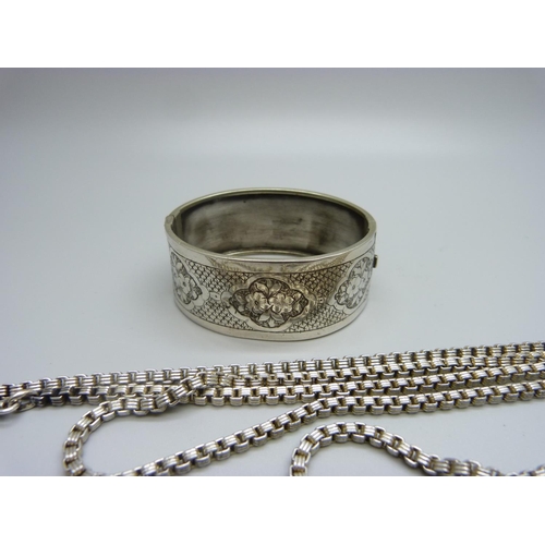 933 - A vintage silver bangle, marked 925, and long guard chain