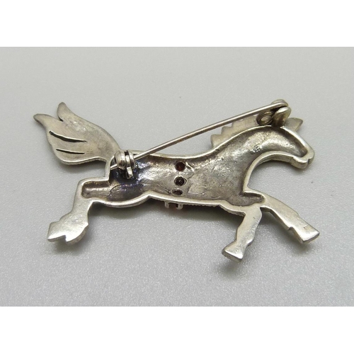 935 - A silver, marcasite and red stone horse brooch