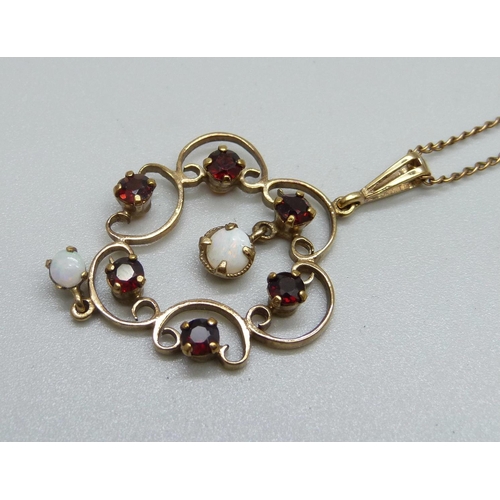 954 - A 9ct gold, Art Nouveau style opal and garnet pendant and chain, 5.5g