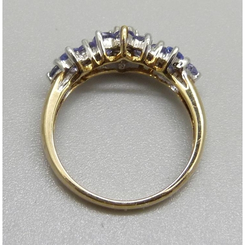 964 - A 9ct gold, triple cluster tanzanite ring, 2g, M