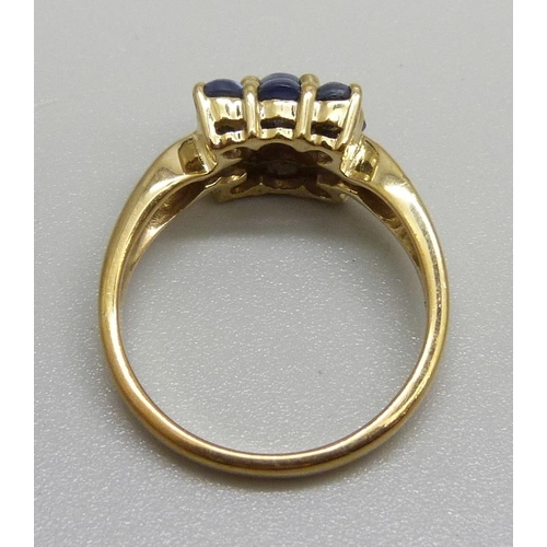 976 - A 9ct gold, nine stone cabochon sapphire ring with diamond shoulders, 3.6g, N