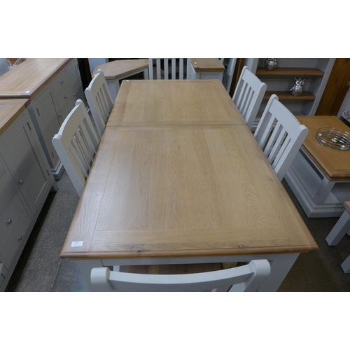 1330 - An extension dining table - 1.8-2.3m and six vertical slatted chairs  * This lot is subject to VAT