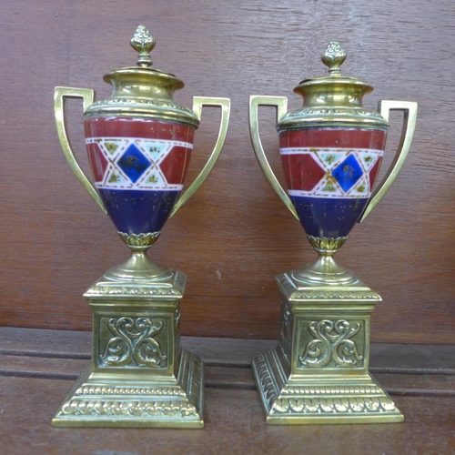 607 - A pair of brass and porcelain garnitures, 23cm