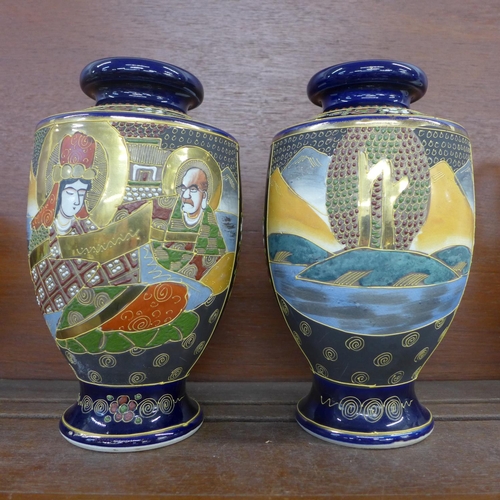 609 - A pair of oriental vases, 23cm