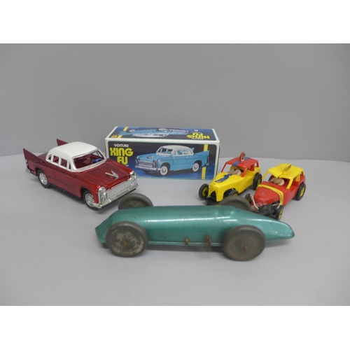 630 - Two slot racing cars, a clockwork racing car and a boxed Xing Fu Sedan model car