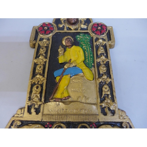 634 - A painted cast iron wall plaque showing Dick Whittington, Rd. No. 19247, 30.5cm