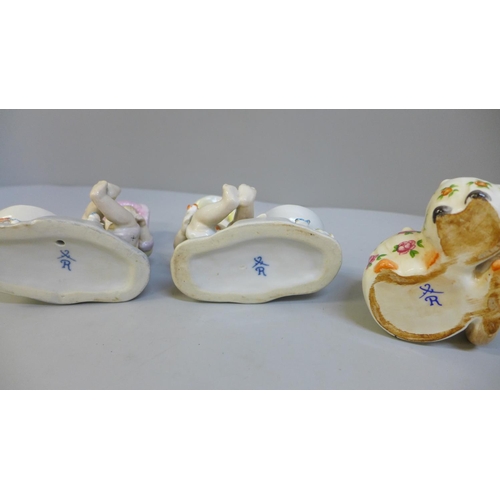 647 - A pair of continental figural salts and a novelty condiment set