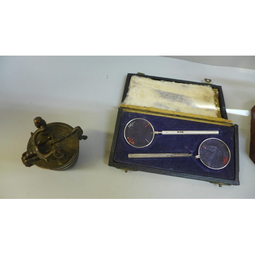 653 - An optician's magnifier, a set of  graduated weights, etc.