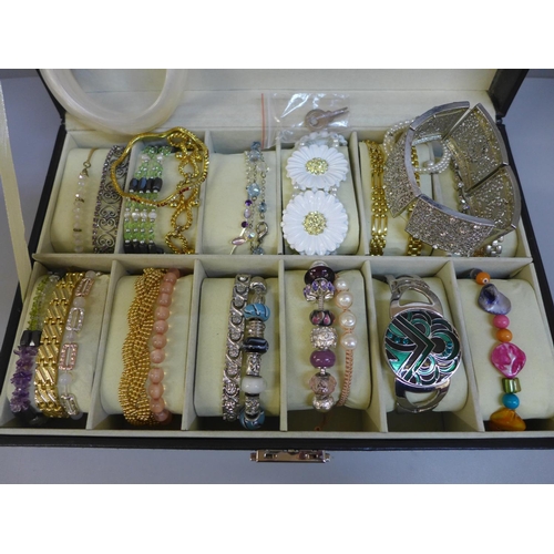 682 - Costume bracelets and bangles in a wristwatch display case