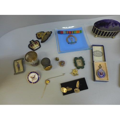 684 - A silver football medal, pin cushion, a pair of hammered metal napkin rings, cigarette case, etc.