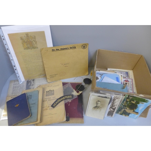 692 - Militaria; a box of military issue items and other military related items including postcards