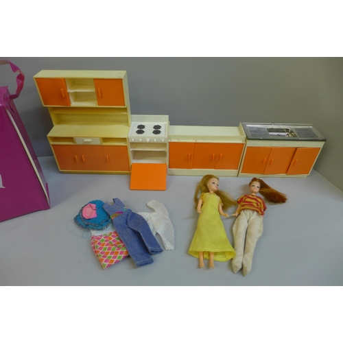 720 - A Pippa carry case, two dolls, clothes and kitchen units