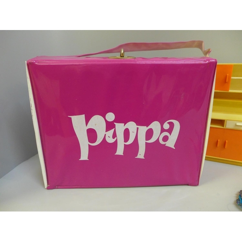 720 - A Pippa carry case, two dolls, clothes and kitchen units