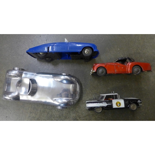 726 - A Japanese tin plate TR3 sports car, Police Car and two more vehicles