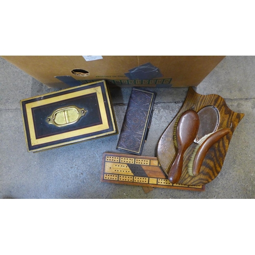 747 - A collection of vintage items; a wooden cribbage board and marker pad, a hall mirror and brush set, ... 