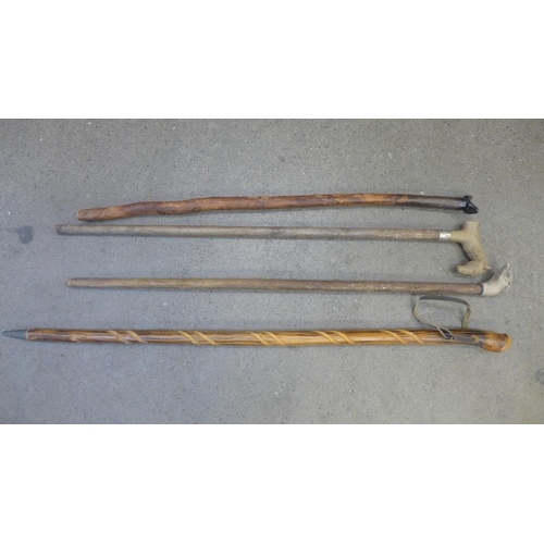 821 - Four walking sticks, one with horse handle, one with bird's head handle