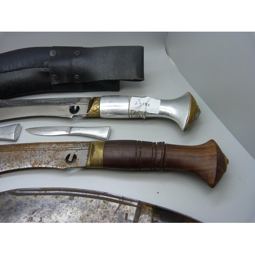 845 - A kukri and two others lacking scabbards