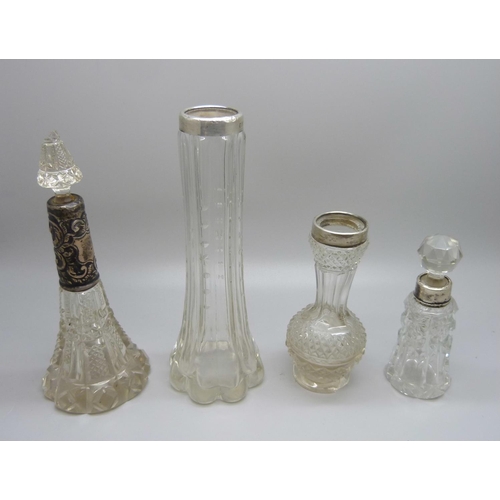 853 - Two silver mounted scent bottles and two silver rimmed bottles, a/f