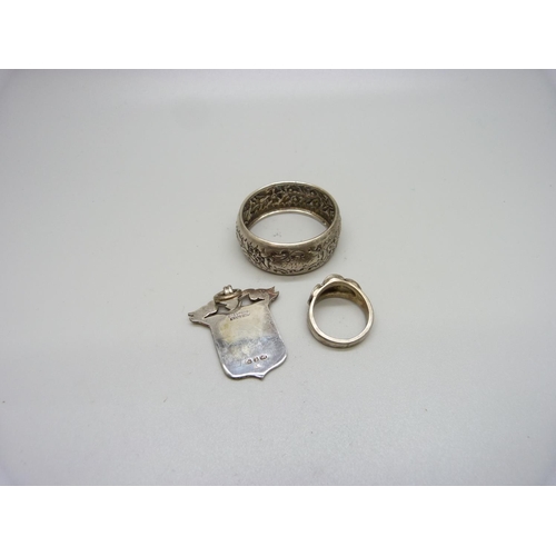 863 - A silver ring, Moller, Trondhjem, P, a silver napkin ring and a late Victorian silver fob, Birmingha... 