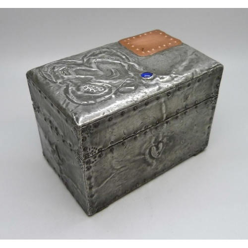 875 - An Arts and Crafts metal covered playing card box, containing two packs of playing cards