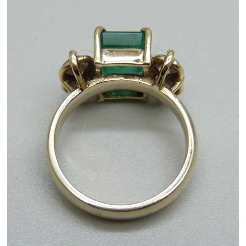 928 - An 18ct gold, emerald and diamond ring, 7.1g, M, emerald 7mm x 11mm