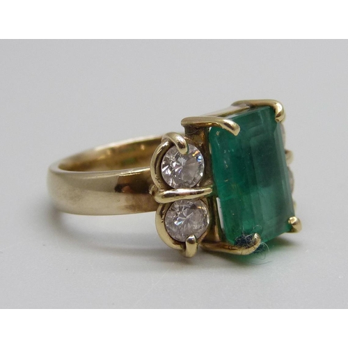 928 - An 18ct gold, emerald and diamond ring, 7.1g, M, emerald 7mm x 11mm