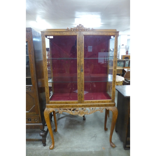 123 - A Queen Anne style burr walnut display cabinet on stand