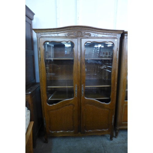 145 - A French carved oak two door bookcase