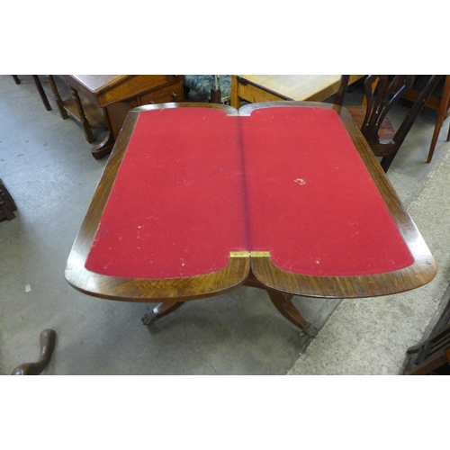 187 - A Victorian figured walnut and Tunbridgeware inlaid fold over games table, on associated base