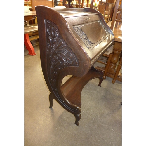 205 - An Art Nouveau carved mahogany bureau de dame and a chair