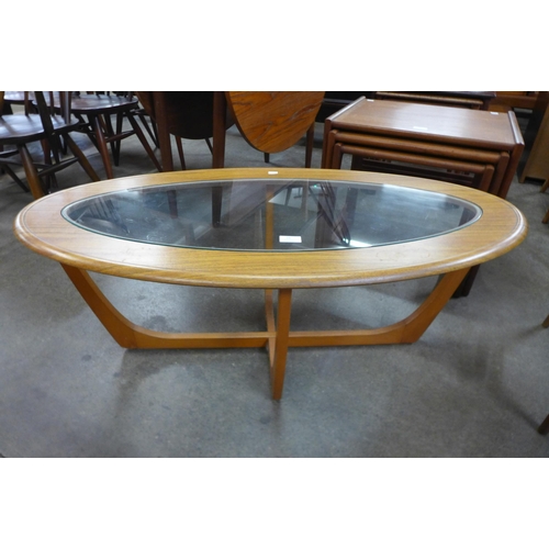34 - A teak and glass topped oval coffee table