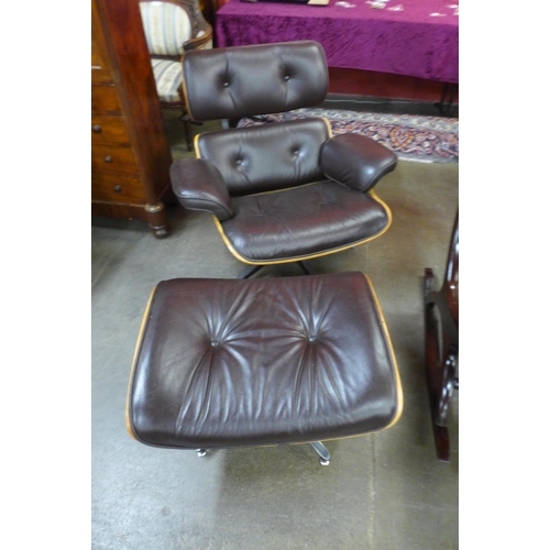 42 - A Charles & Ray Eames style simulated rosewood and brown leather revolving lounge chair and stool