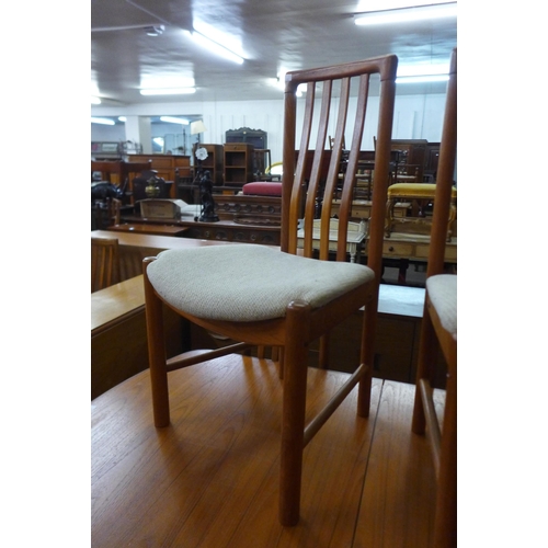 47 - A teak extending dining table and six chairs