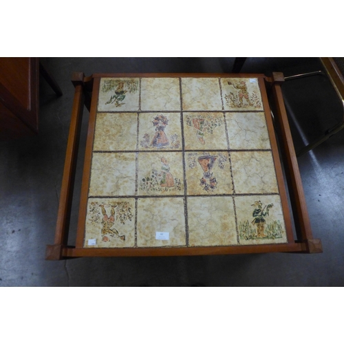 62 - A Scandanavian teak and tiled top coffee table