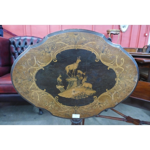 86 - A 19th Century Black Forest carved and inlaid softwood tilt top tripod table