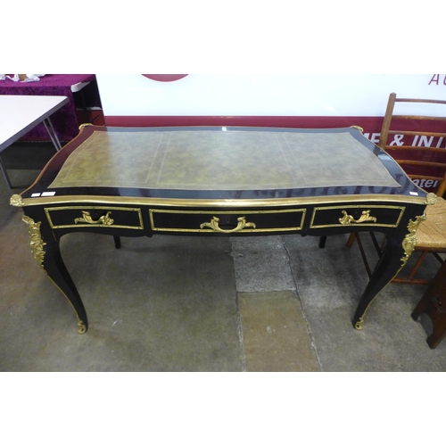 93 - A French ebonised, ormolu and green leather topped three drawer writing table