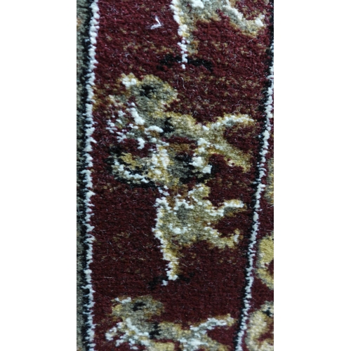 1415 - A claret ground full wool pile runner, with bespoke design depicting animals, 240cm x 70cm